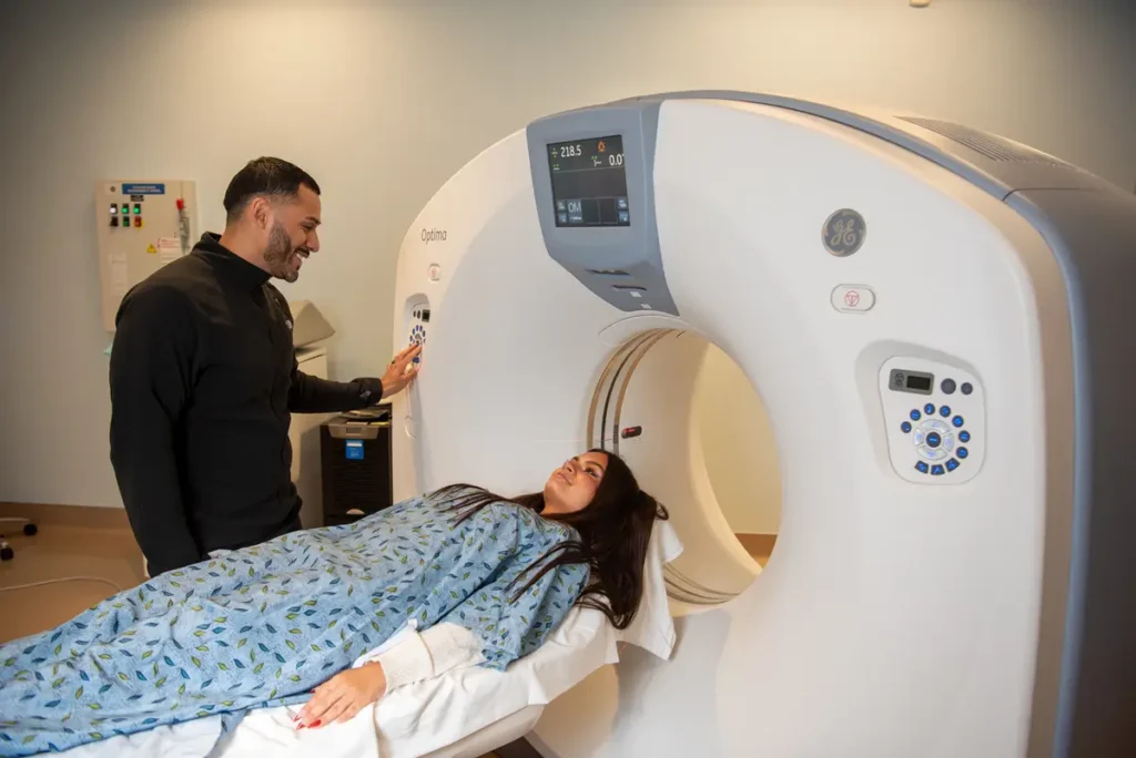 Imaging technician guiding Physicians Premier ER patient through MRI scan