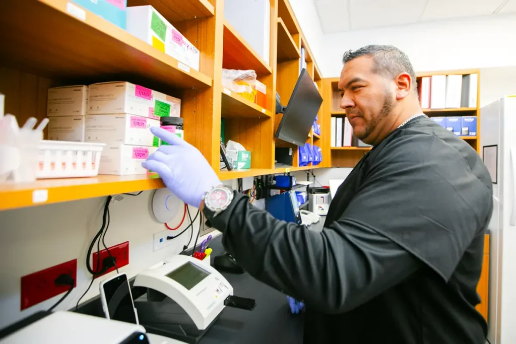 Medical lab technician testing samples in Physicians Premier ER facility