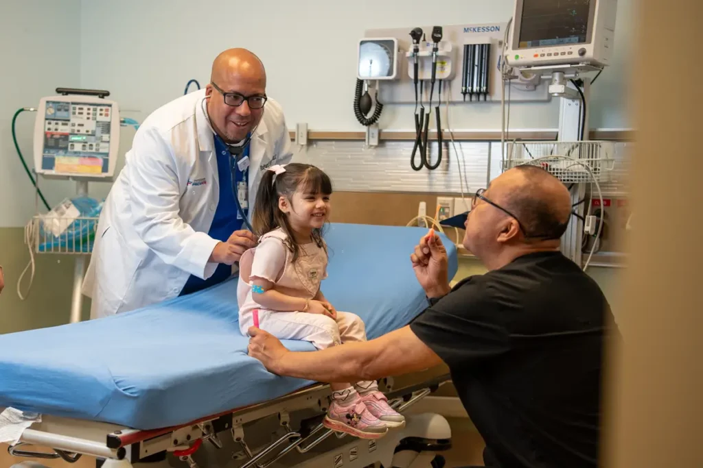 Physicians Premier ER doctor and nurse with young girl in treatment room