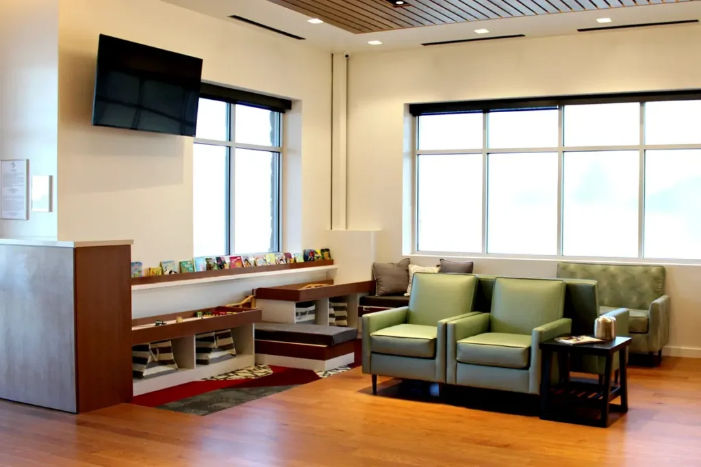 Physicians Premier ER waiting area with seating, television, and play area